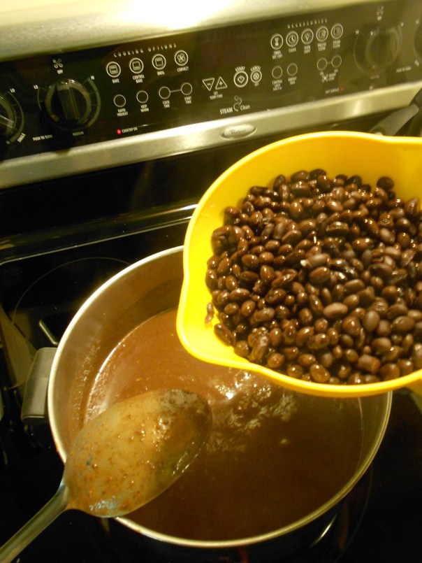 Adding the beans to my bean soup.